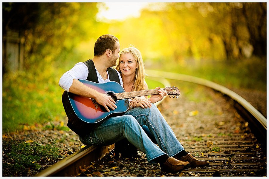 couple by railroad tracks